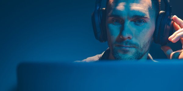 podcaster with headphones and computer